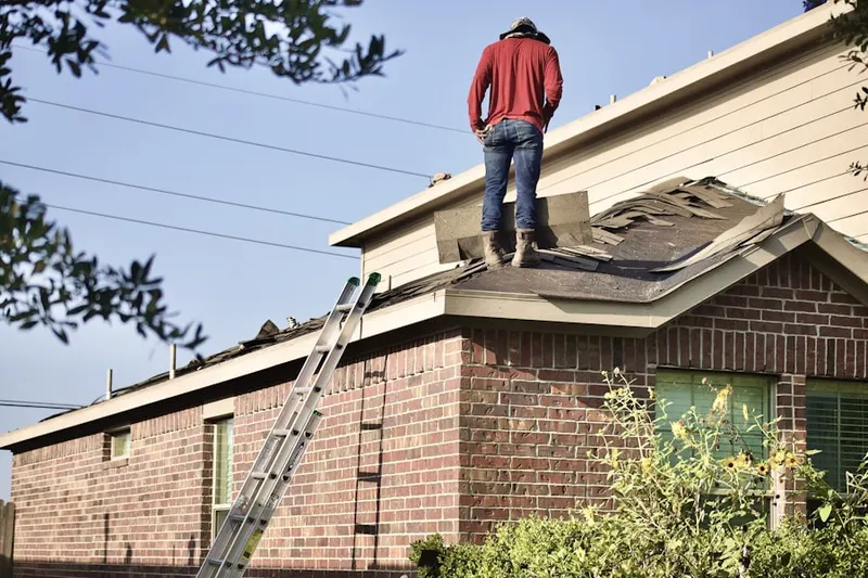 Professional roofer working on a residential roof in Monroeville